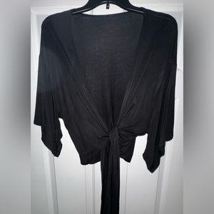 Black jersey wrap top with shirt sleeves. NEVER WORN.